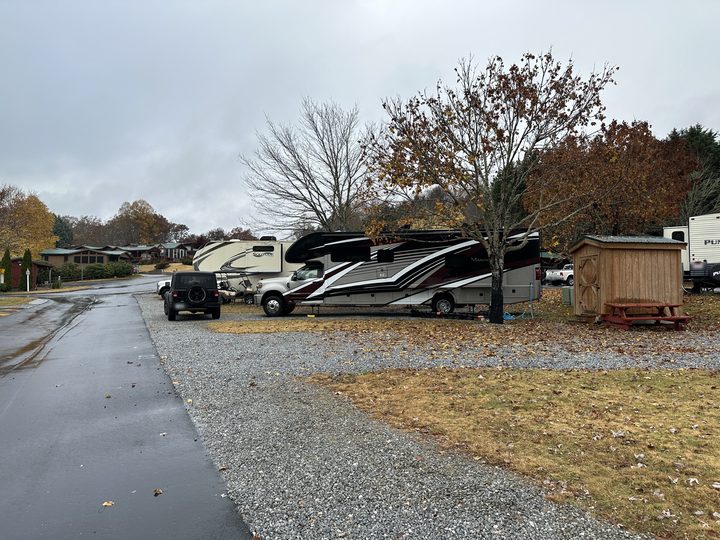 The motorhome under fall trees